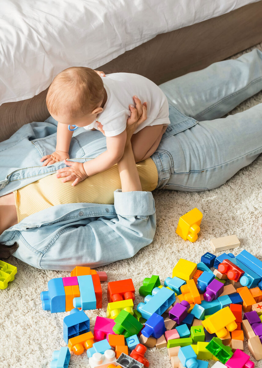 mom baby on floor with blocks